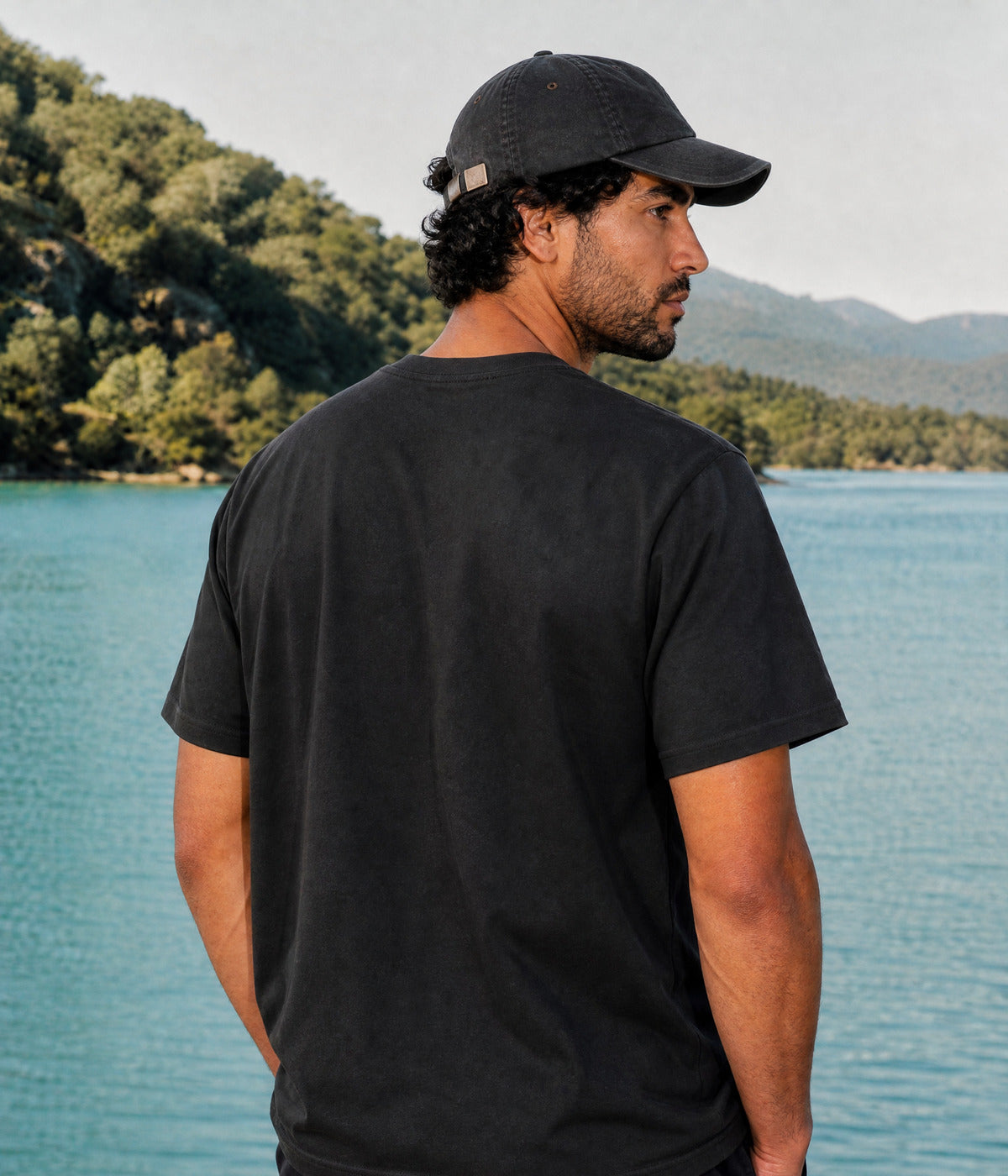 LOGO TEE. BLACK worn by a man, back view
