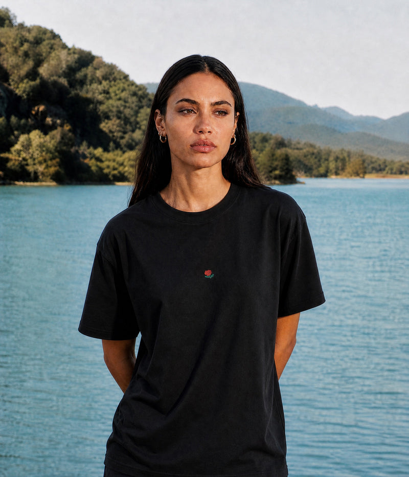 ROSE TEE. BLACK worn by a woman