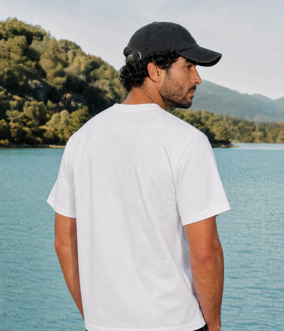 MOUNTAINS TEE. WHITE worn by a man, back view