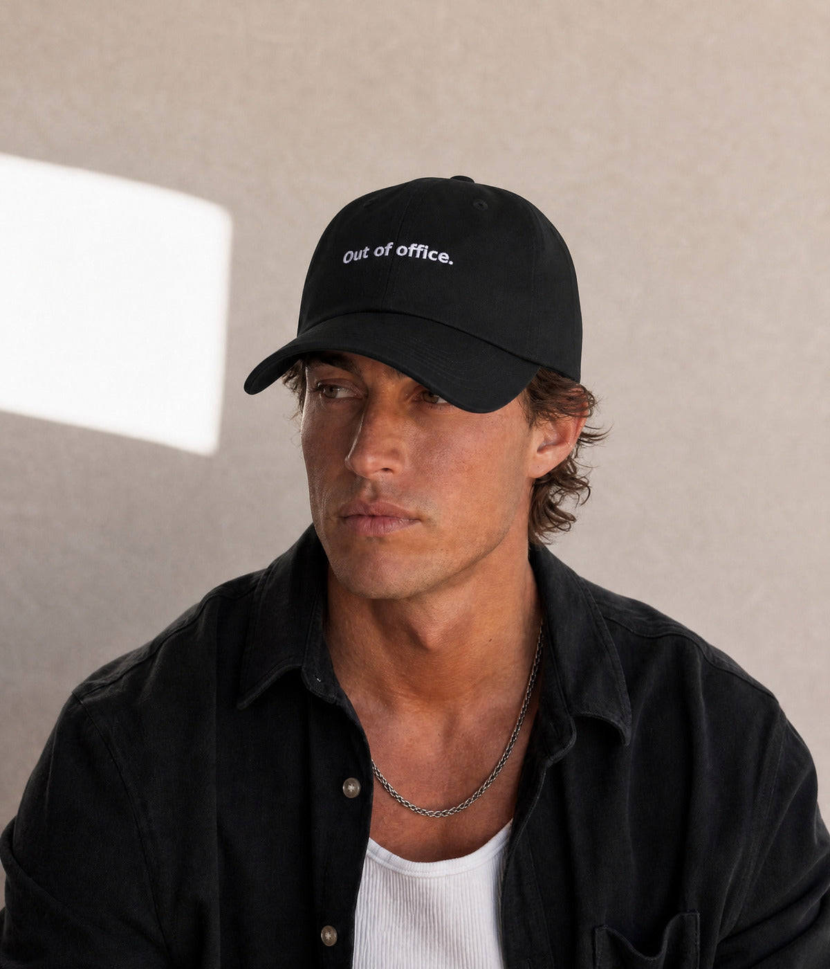 OUT OF OFFICE - DAD CAP. worn by a man