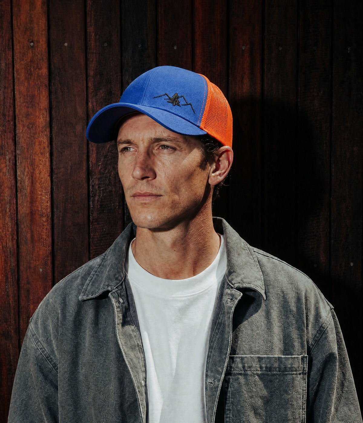PATCHWORK TREE TRUCKER. BLUE worn by a man
