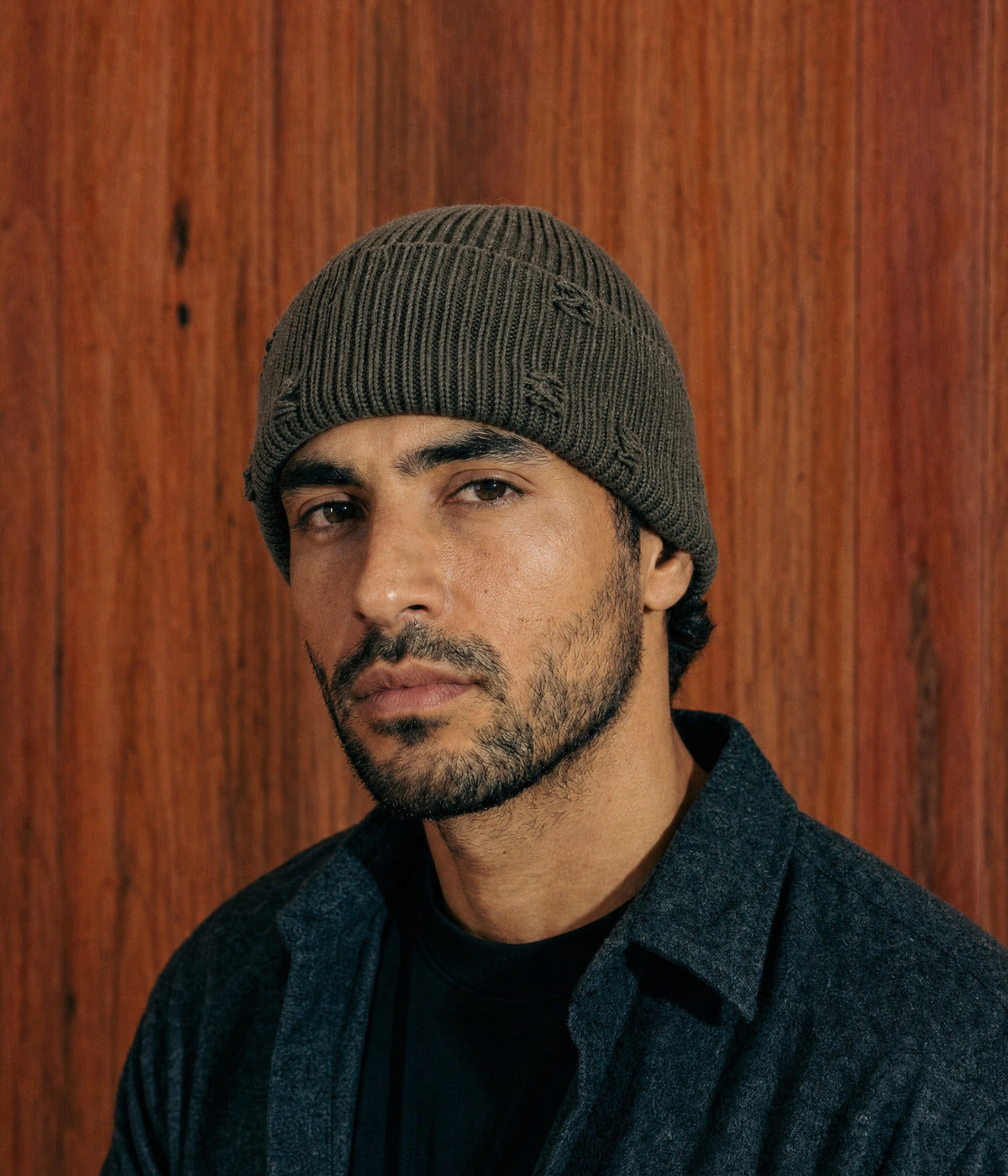 RIPPED FISHERMAN BEANIE. — DARK GREEN worn