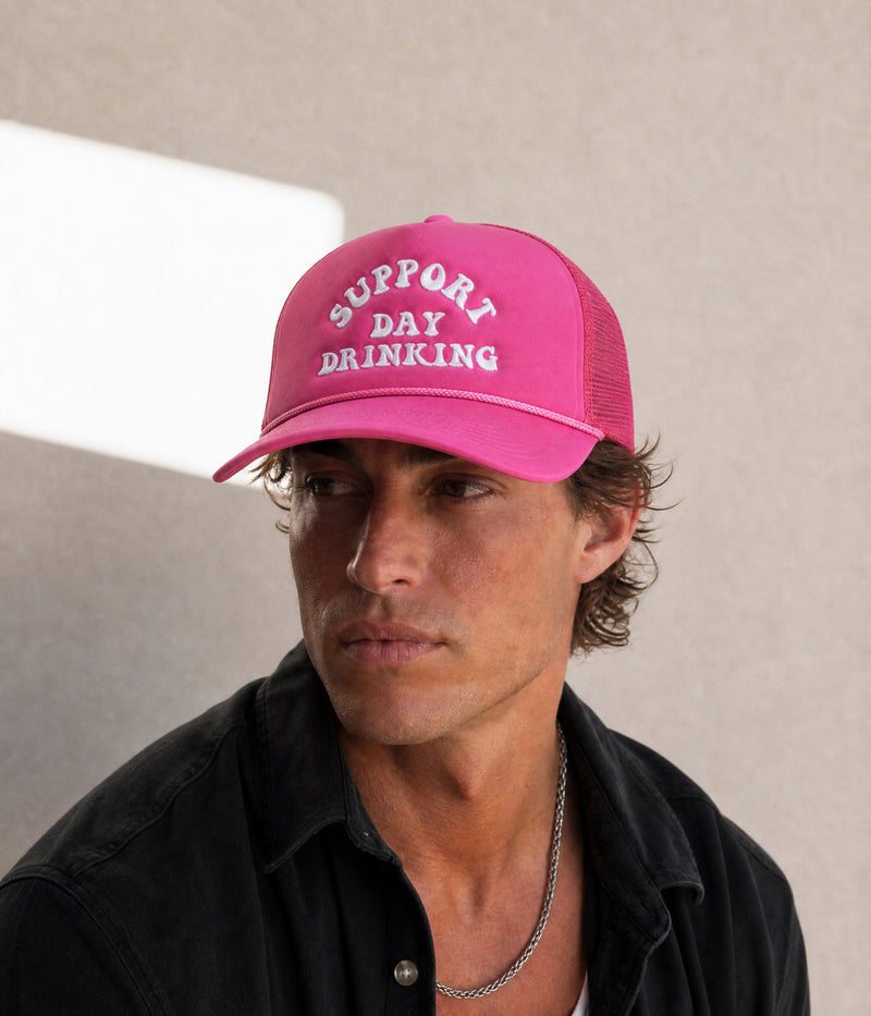 SUPPORT DAY DRINKING TRUCKER. ROSE worn by a man